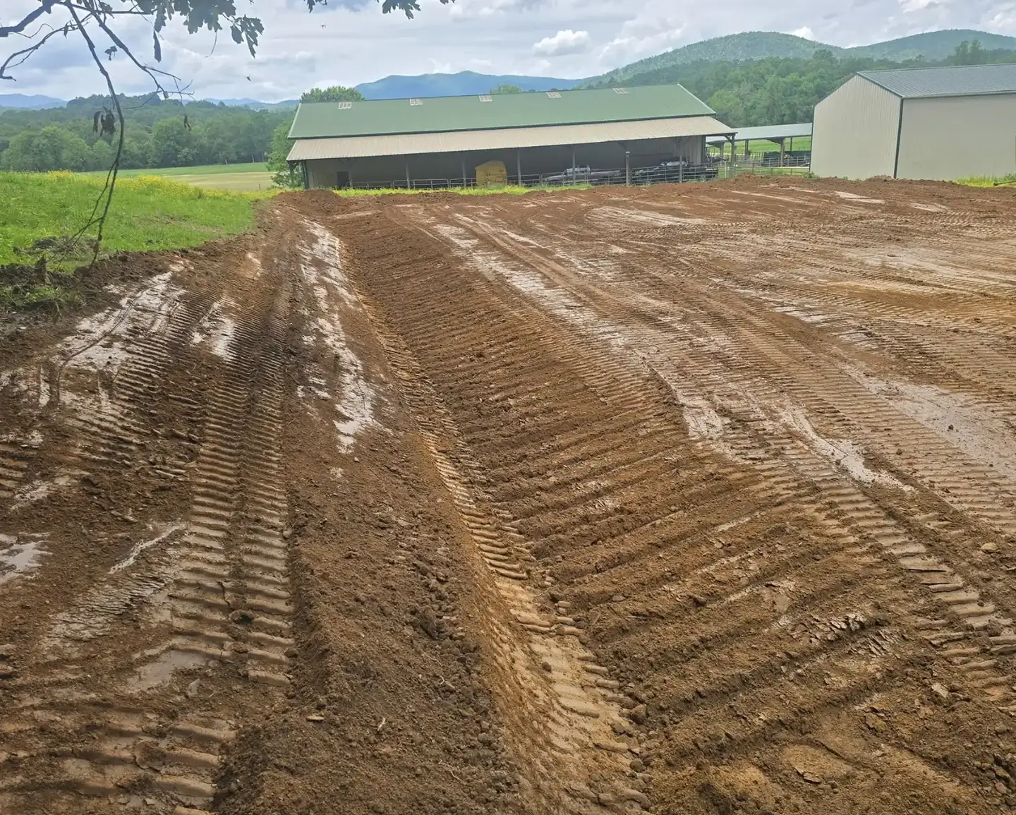 A slope cut and graded on a farm with the mountains behind it &mdash; Little Acres Grading