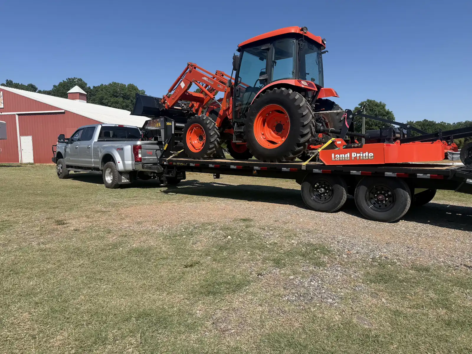 A tractor and rotary cutter loaded out and ready for a brush hogging job &mdash; Little Acres Grading